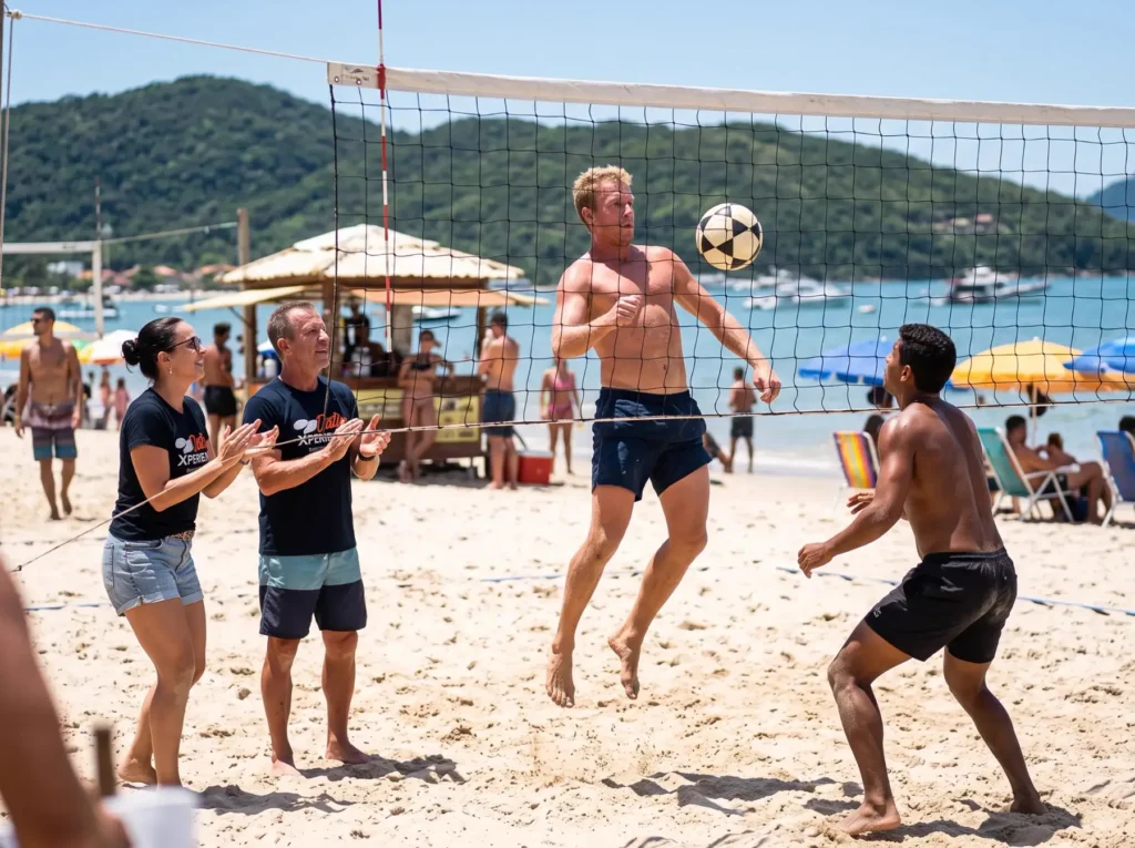 Guests playing footvolley on a Florianópolis beach while two local hosts cheer from the sand